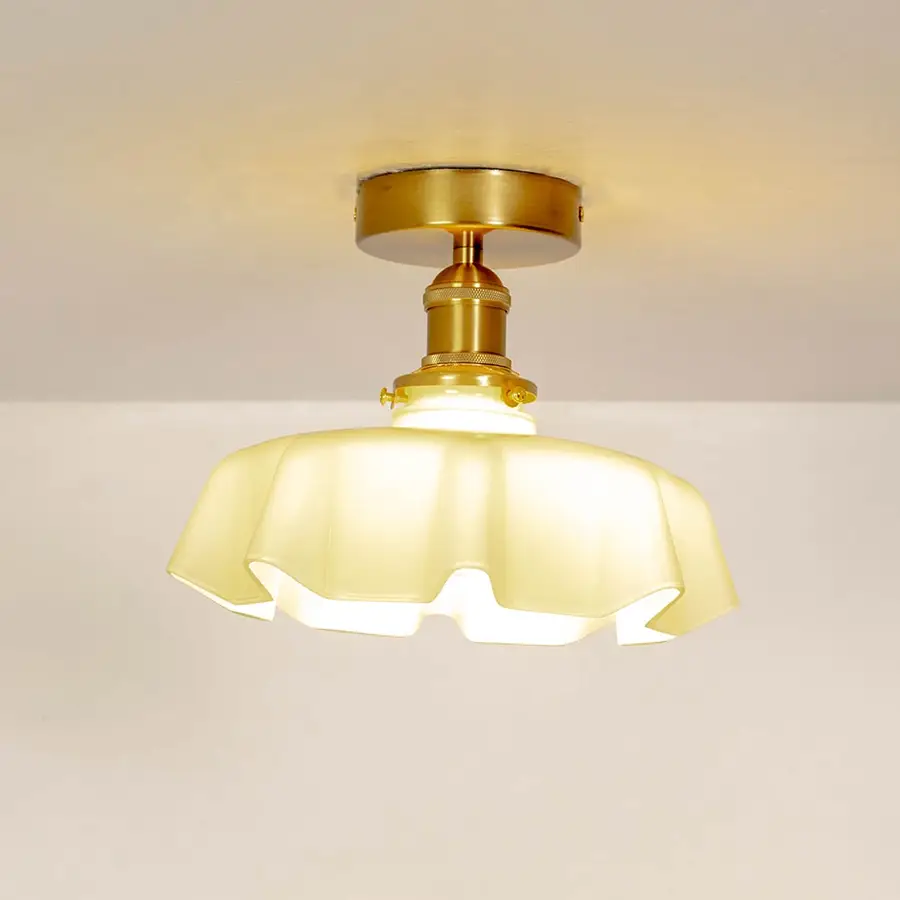 Mint green ruffled ceiling light shown off on a white background with a smooth gold mount.