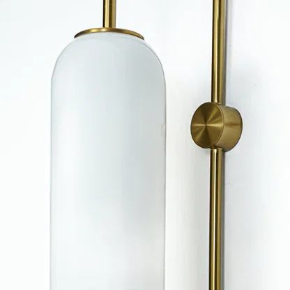 Closeup of white frosted glass and gold metal wall light for modern hallway and premium decor styling spaces.