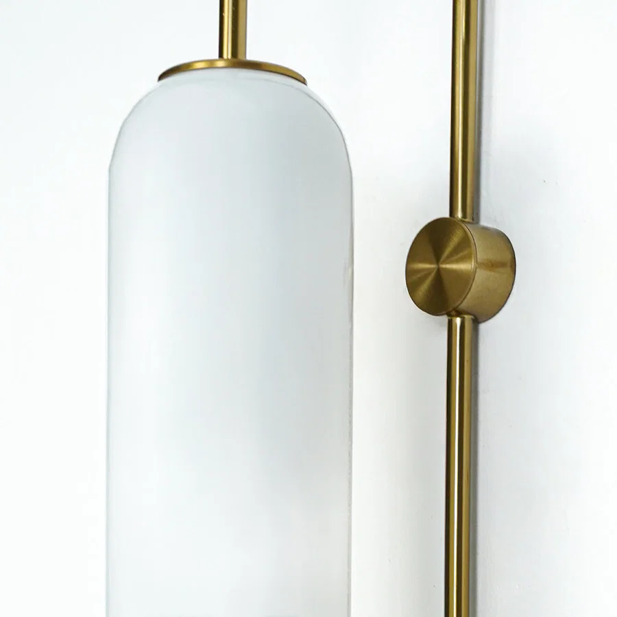 Closeup of white frosted glass and gold metal wall light for modern hallway and premium decor styling spaces.