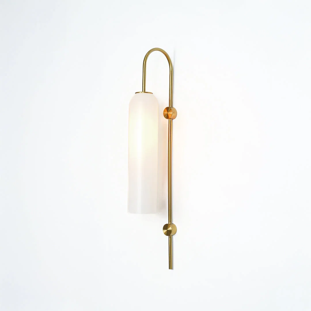 Modern gold metal wall light with white frosted glass shade for stylish bedroom and luxury decor spaces.

