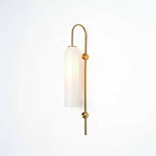 Modern gold metal wall light with white frosted glass shade for stylish bedroom and luxury decor spaces.

