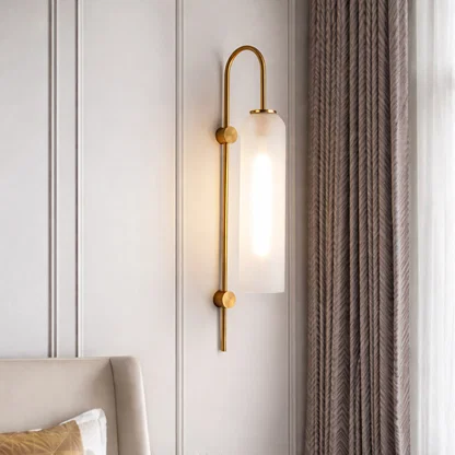 Modern gold metal wall light with frosted glass shade for elegant bedroom and luxury decor styling spaces.