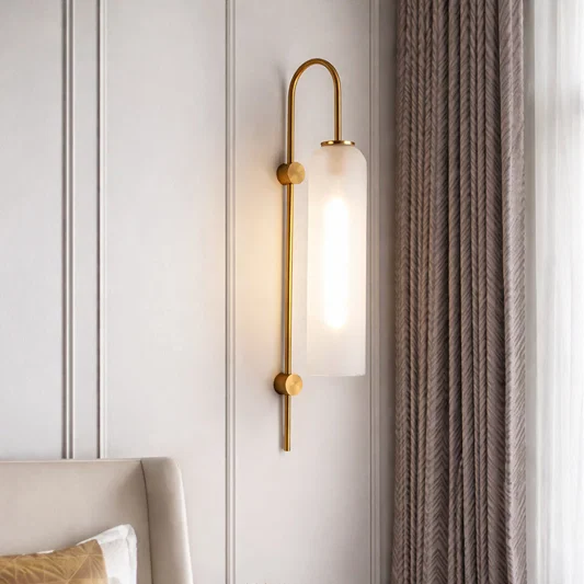 Modern gold metal wall light with frosted glass shade for elegant bedroom and luxury decor styling spaces.