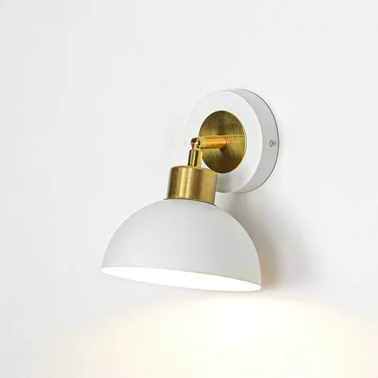 Wall light with white dome shade and gold metal mount ideal for bedroom or living room wall decor placement on clean background.