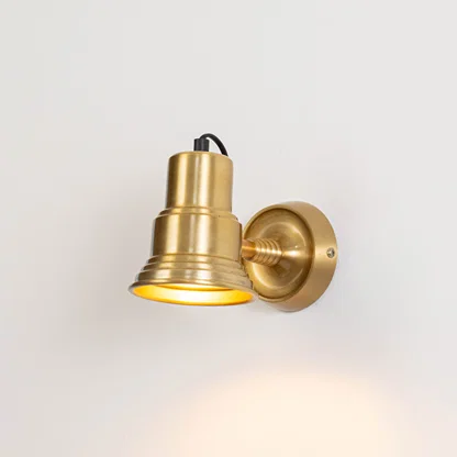Classic metal wall light in gold finish with angled shade for indoor or outdoor accent lighting decor placement white background.