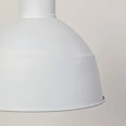 Closeup of white metal dome pendant light highlighting smooth finish and premium craftsmanship.