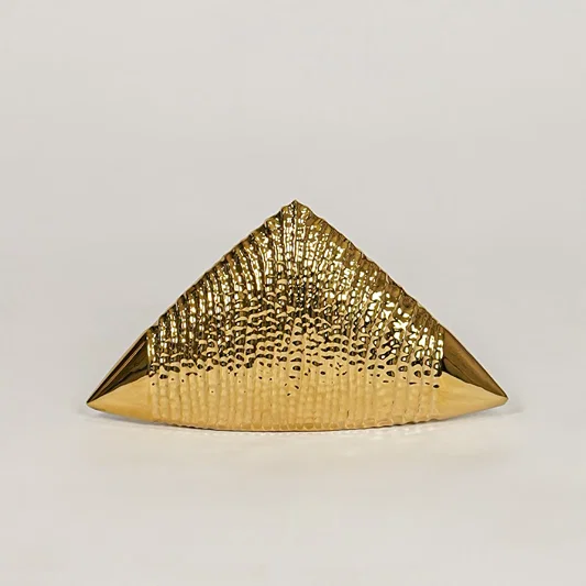Gold metal pyramid decor accent with textured finish for modern tabletop shelf and console decor placement.
