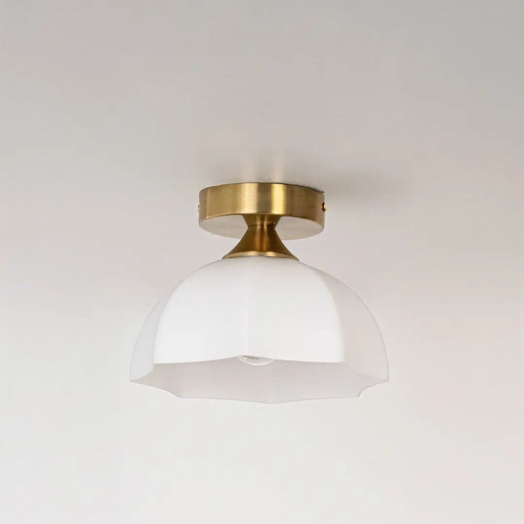 Modern white glass and gold metal ceiling light for stylish bedroom and premium interior decor styling spaces.