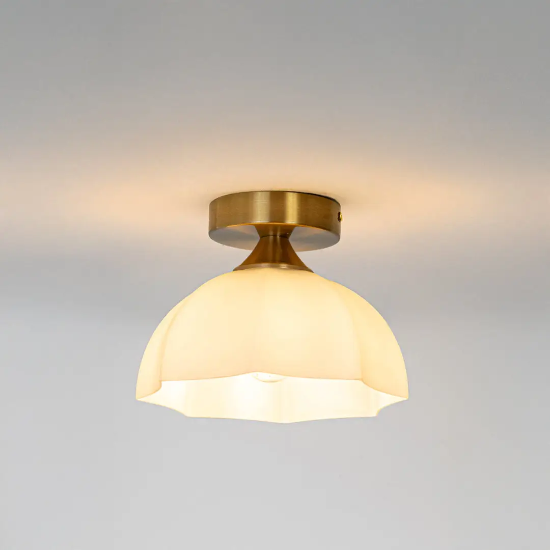 Modern white glass and gold metal ceiling light with warm glow for luxury hallway and traditional decor styling spaces.