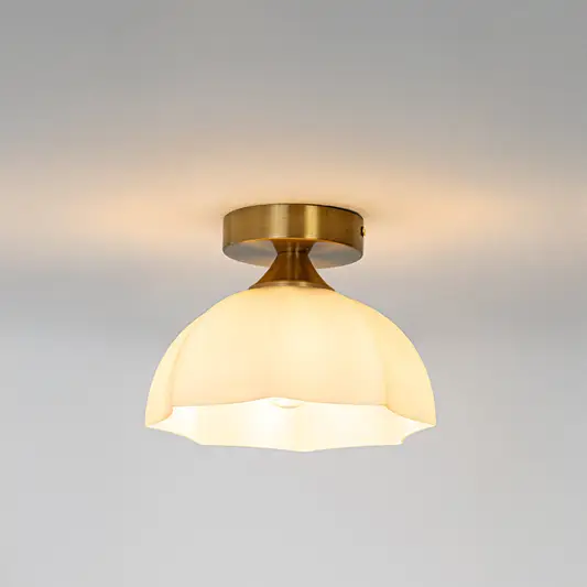 Modern white glass and gold metal ceiling light with warm glow for luxury hallway and traditional decor styling spaces.