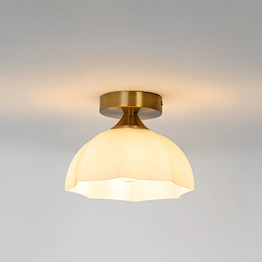 Modern white glass and gold metal ceiling light with warm glow for luxury hallway and traditional decor styling spaces.