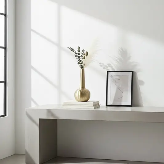 Gold metal decorative vase lifestyle image on modern console table for elegant minimalist home decor.