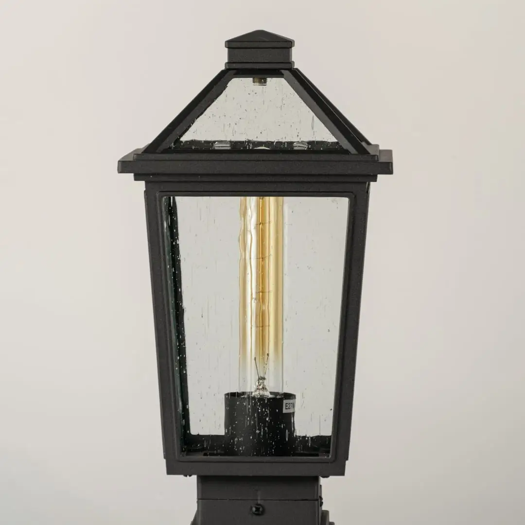 Black outdoor lantern Closeup showing the detailed metal finish and the clear pebbled glass panels.