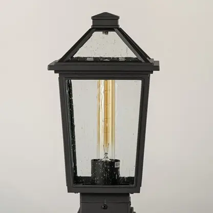 Black outdoor lantern Closeup showing the detailed metal finish and the clear pebbled glass panels.