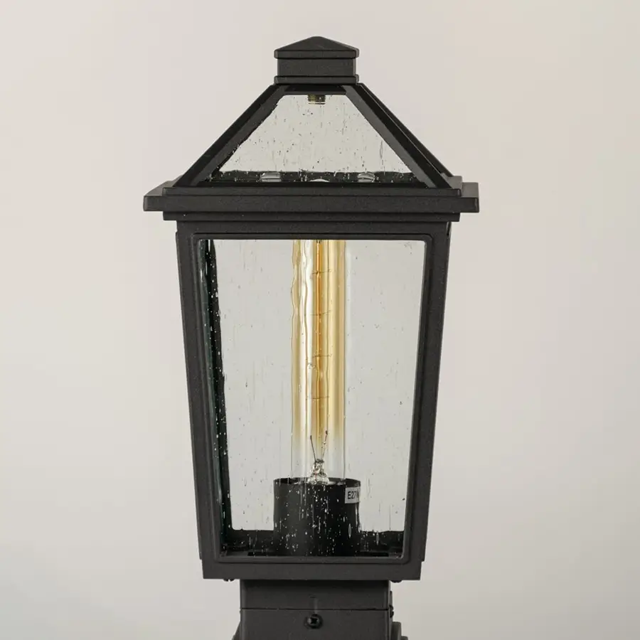 Black outdoor lantern Closeup showing the detailed metal finish and the clear pebbled glass panels.