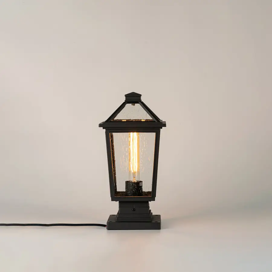 Black outdoor gate light with ribbed glass panels for stylish modern exterior decor use.