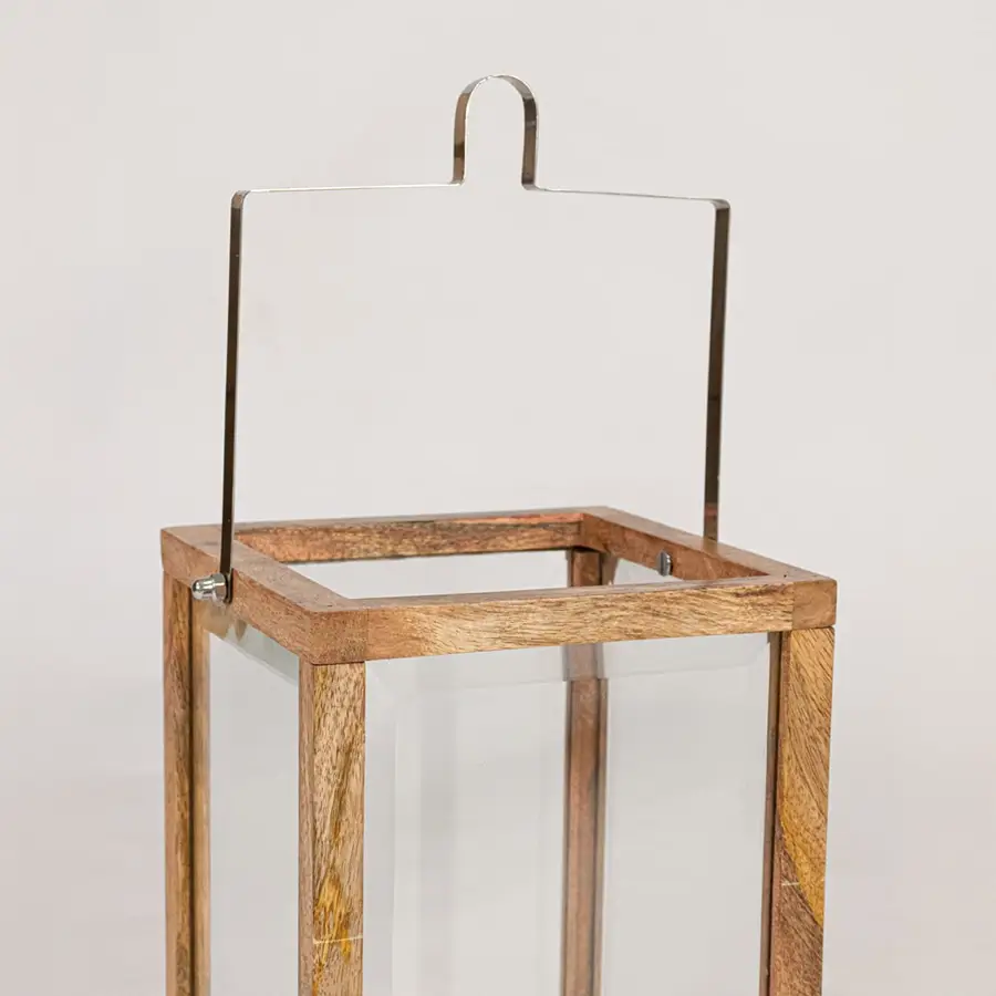 Closeup of wooden frame lantern showing natural wood grain clear glass panels and sturdy handcrafted decorative structure.