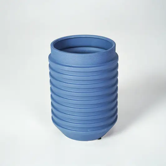 Blue ceramic ribbed planter vase for modern tabletop decor styling with elegant matte finish on white background.