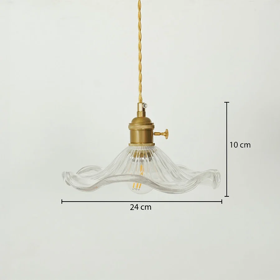 A clear ribbed glass pendant light with a brass fitting and gold-toned cord, shown against a light gray background with dimension markers indicating 24 cm width and 10 cm height.