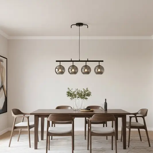 Modern black and chrome chandelier with four reflective glass globes adding luxury style and soft ambient glow to home interiors.