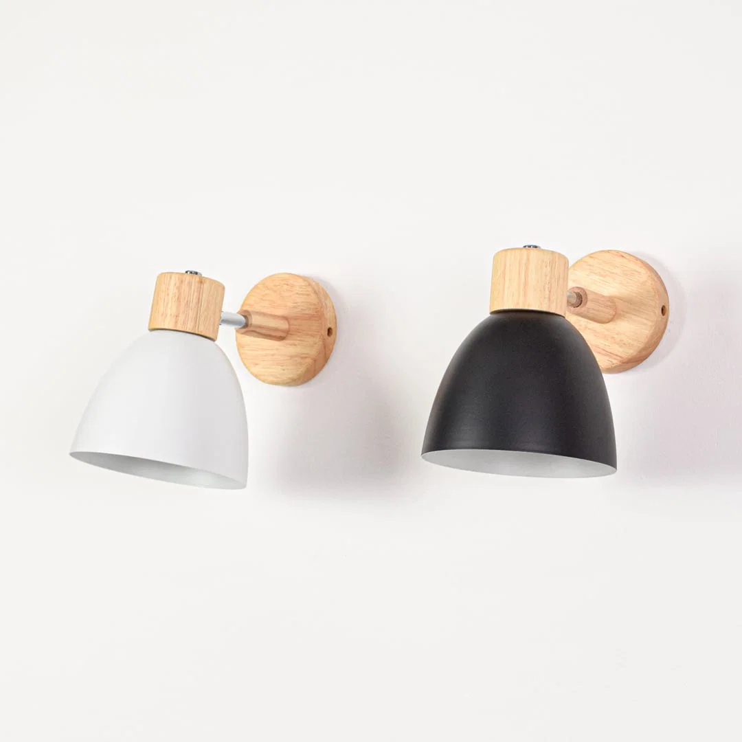 Grouped wall mounted lights with metal shades switched off displaying color contrast wood details and clean modern styling.