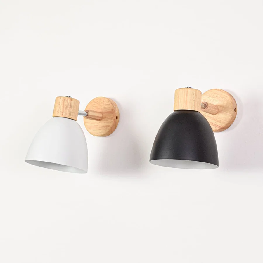 Grouped wall mounted lights with metal shades switched off displaying color contrast wood details and clean modern styling.