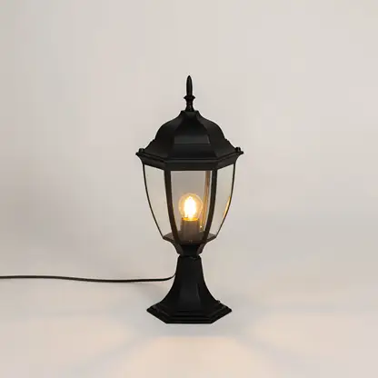 Classic black outdoor gate light with warm glowing bulb for stylish exterior decor styling use.