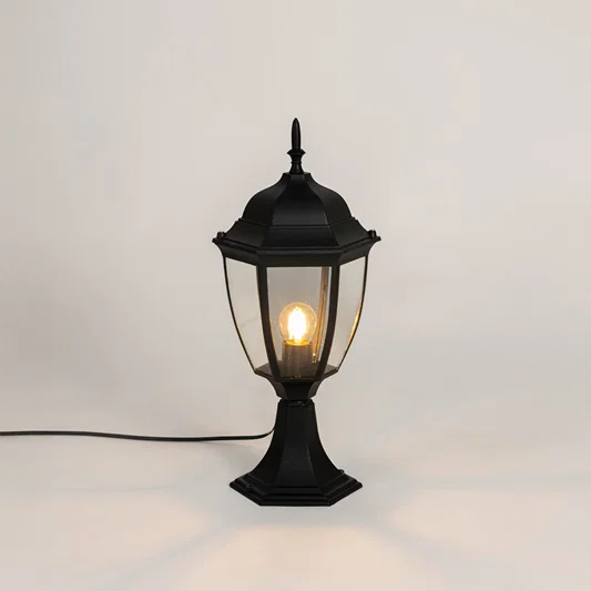 Classic black outdoor gate light with warm glowing bulb for stylish exterior decor styling use.