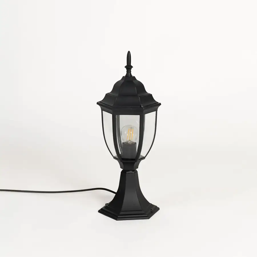 Black outdoor pillar lamp with clear glass panels and hexagonal base ideal for garden patio driveway and terrace use.