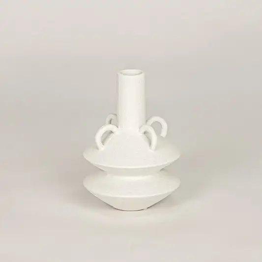 White ceramic flower vase with sculpted handle design for modern tabletop shelf and console decor placement.