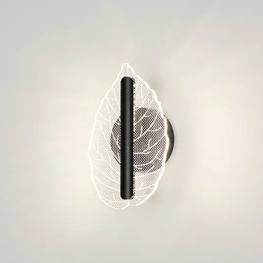 Contemporary wall light with leaf design in metal finish for bedroom or living room decor lighting placement white background.