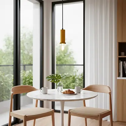 Gold metal pendant light above dining table adding Scandinavian elegance and warm ambient lighting to modern interiors.