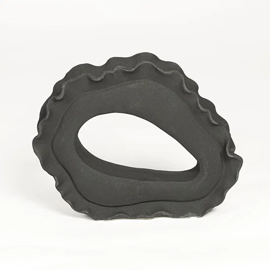 Contemporary dark grey ceramic artistic sculpture for minimalist living room decor placement.