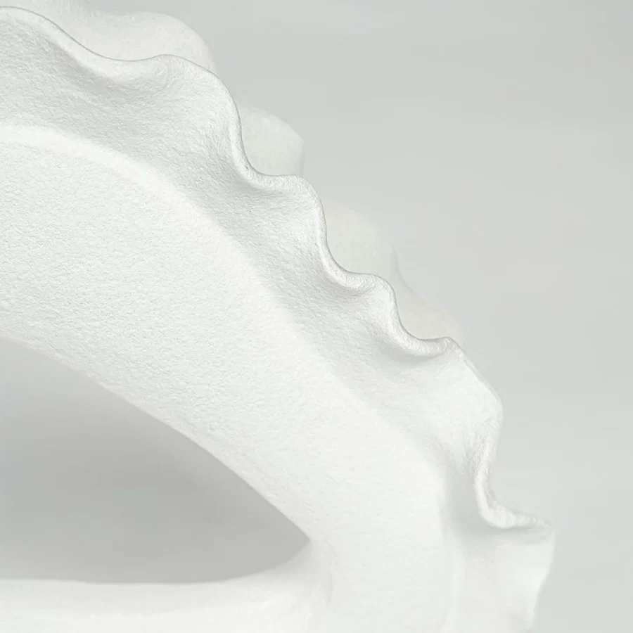 Closeup of white ceramic decorative bowl with scalloped edge showcasing premium craftsmanship and elegant modern styling.