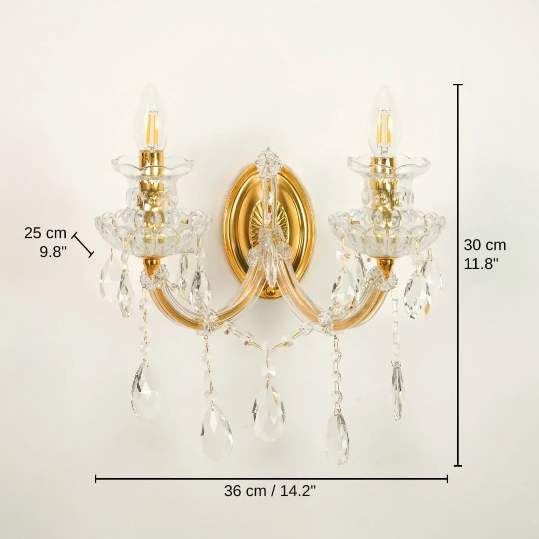 Two-light wall sconce with gold-finished metal arms and clear crystal prisms, base 30 x 36 x 25 cm (11.8 x 14.2 x 9.8 inches), canopy 16 x 11 cm (6.3 x 4.3 inches) dimensions