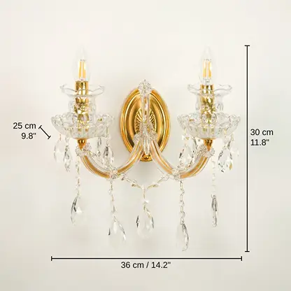 Two-light wall sconce with gold-finished metal arms and clear crystal prisms, base 30 x 36 x 25 cm (11.8 x 14.2 x 9.8 inches), canopy 16 x 11 cm (6.3 x 4.3 inches) dimensions