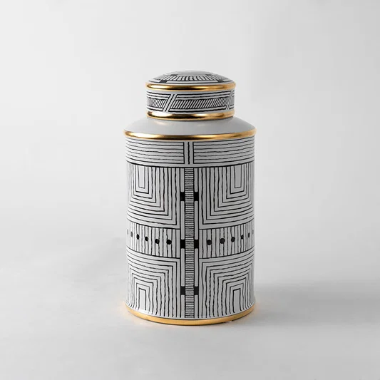 White ceramic decorative jar with geometric black pattern and gold lid for modern shelf styling and home decor.