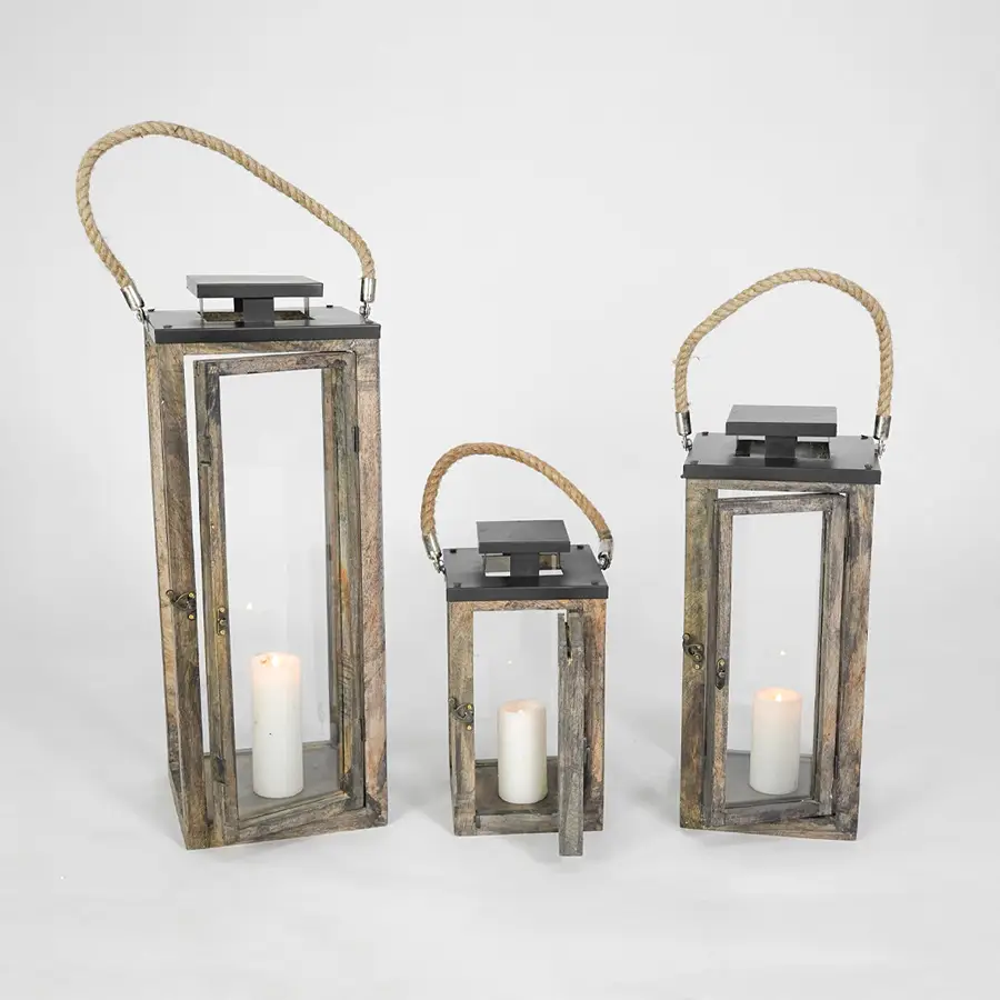 Set of three wooden lanterns with candles on a white background