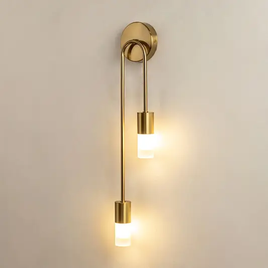 Modern gold metal wall light glowing on beige wall for elegant bedroom hallway and luxury interior decor styling.