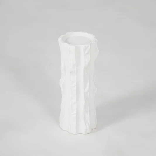 White textured ceramic vase for modern shelf placement and elegant indoor home decor styling accent piece.