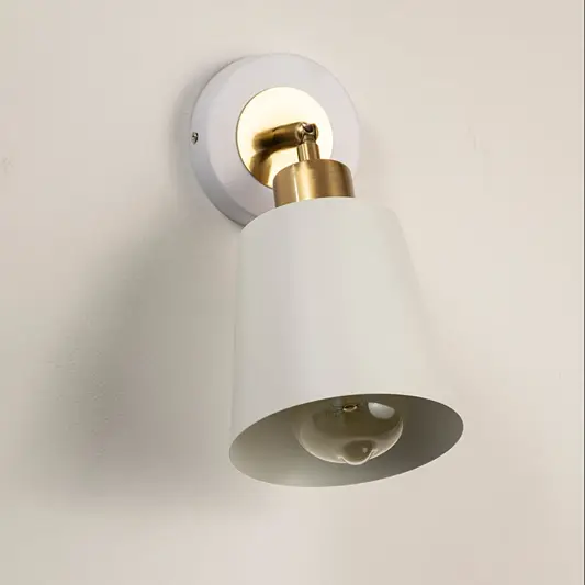 Modern white metal spotlight wall light with brass accents for elegant interior lighting decor.
