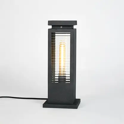 Black metal outdoor bollard light with clear glass panels for modern exterior lighting decor placement styling.