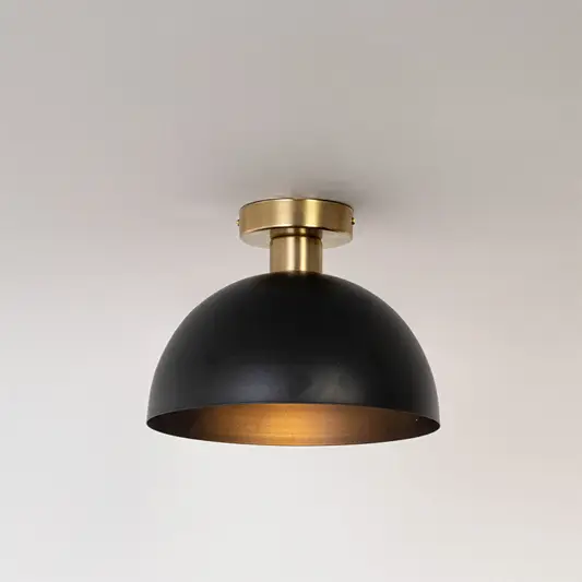 Modern black metal dome ceiling light with warm glow for contemporary bedroom and minimalist decor styling spaces.