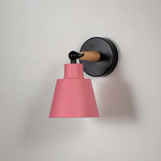 Wooden wall sconce with pink conical lampshade light off white background for bedroom study and hallway modern decorative wall lighting decor.