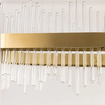 Detailed closeup of gold metal chandelier showing the textured glass rods and gold finish ideal for luxurious modern home decor.
