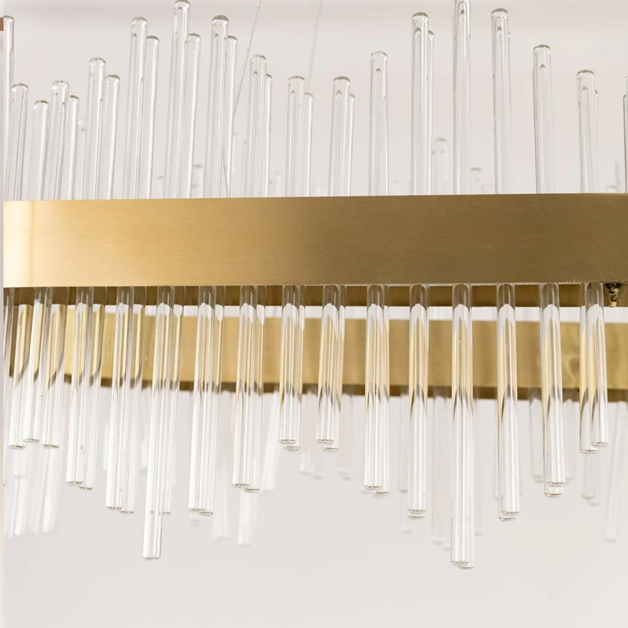 Detailed closeup of gold metal chandelier showing the textured glass rods and gold finish ideal for luxurious modern home decor.