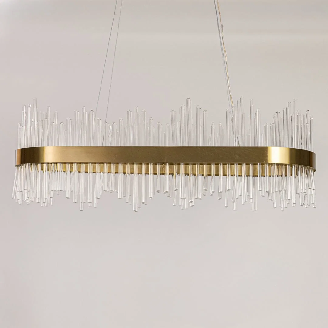 Gold metal chandelier with vertical glass rods displayed with lights off on a white background showing its sleek contemporary structure.