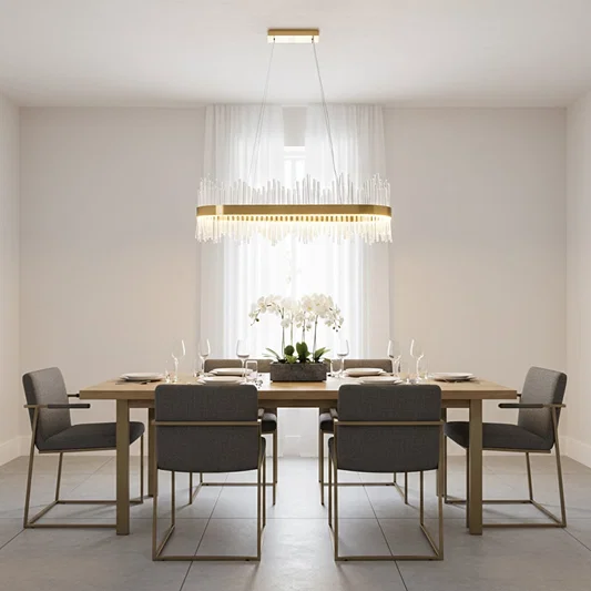 Gold metal chandelier with clear glass rods glowing warmly above a modern dining table creating an elegant bright and luxurious interior atmosphere.