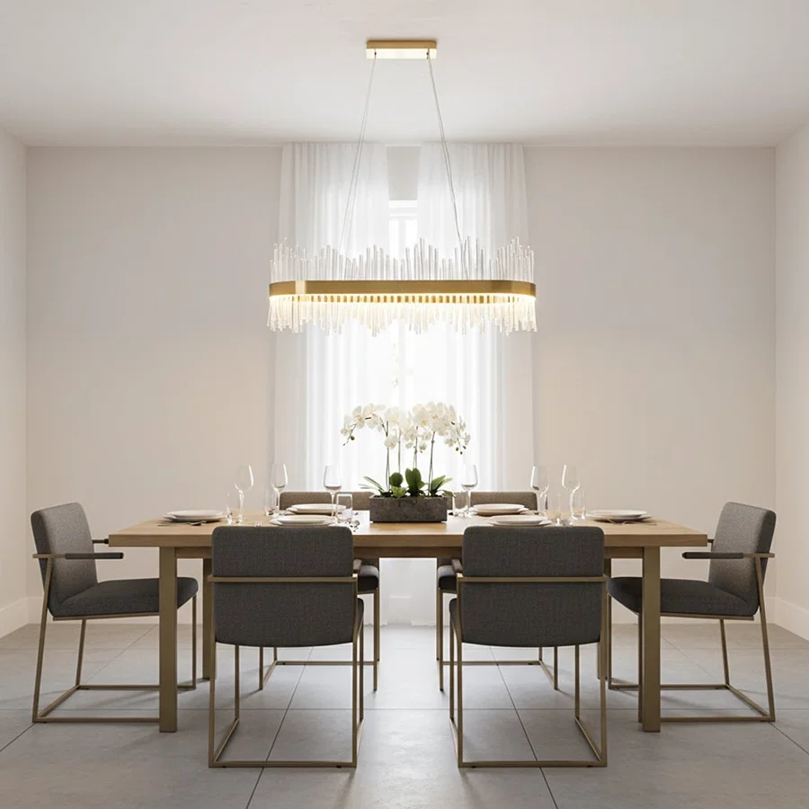 Gold metal chandelier with clear glass rods glowing warmly above a modern dining table creating an elegant bright and luxurious interior atmosphere.
