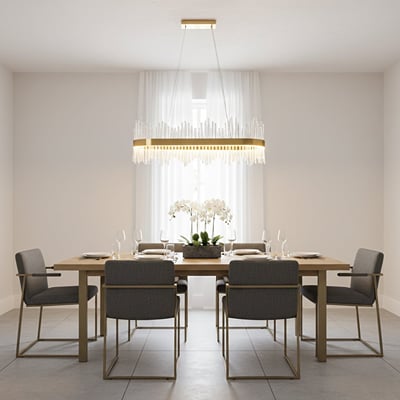 Gold metal chandelier with clear glass rods glowing warmly above a modern dining table creating an elegant bright and luxurious interior atmosphere.